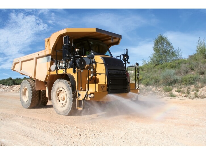 Dump truck with water-based dust suppression
