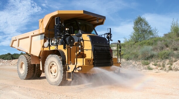 Water powered dust suppression for dumpers